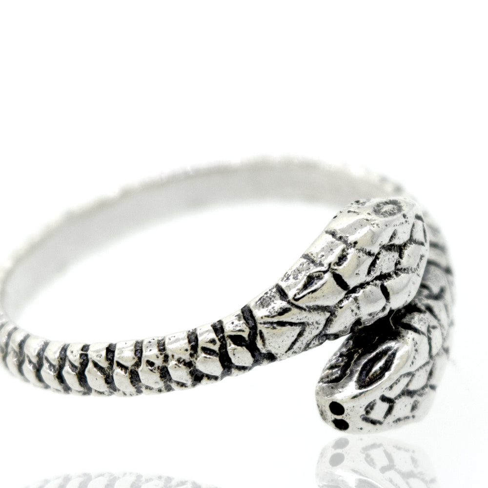 
                  
                    A Super Silver sterling silver two headed snake ring on a white surface.
                  
                