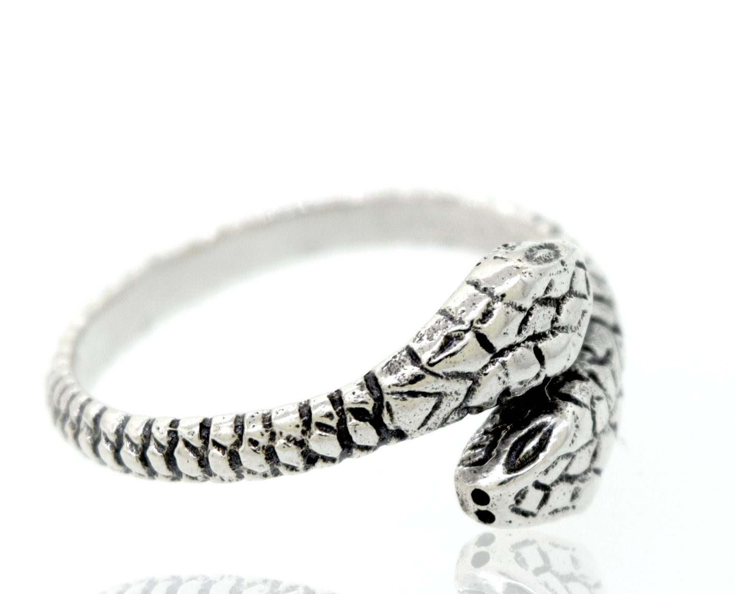 
                  
                    A Super Silver sterling silver two headed snake ring on a white surface.
                  
                