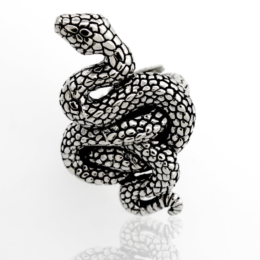 
                  
                    A Coiled Snake Ring by Super Silver, made of .925 Sterling Silver with an adjustable band, resting on a white surface.
                  
                