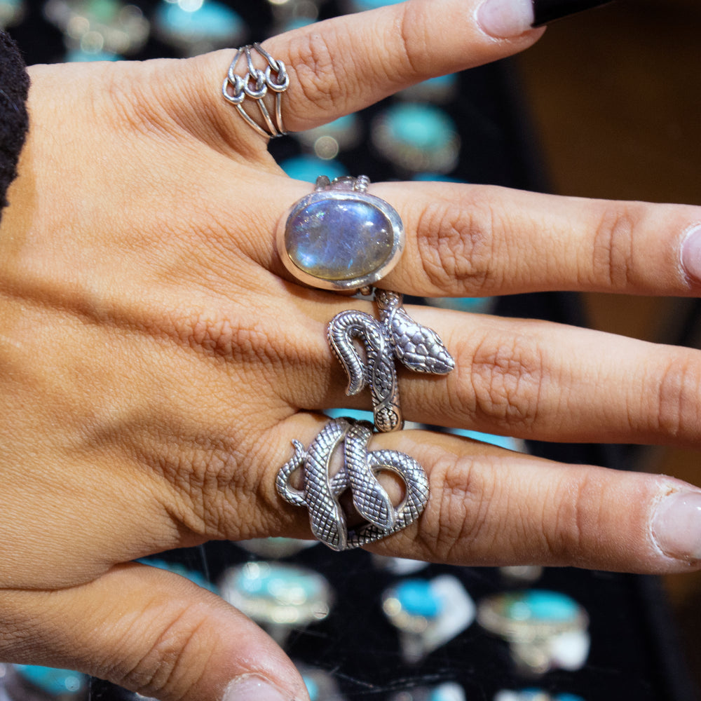 
                  
                    A handcrafted Super Silver Double Headed Snake Ring beautifully adorns a woman's hand.
                  
                