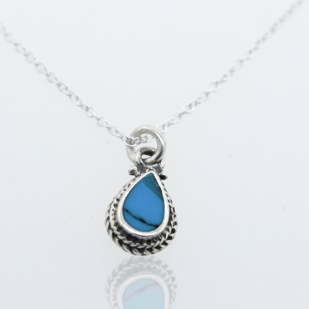 A Super Silver Blue Turquoise Teardrop Necklace with a 18" chain and a small teardrop pendant featuring a blue turquoise stone.