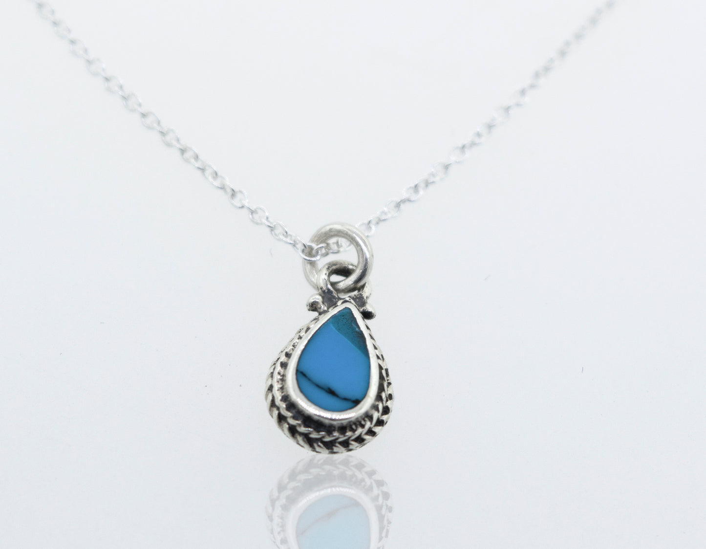 A Super Silver Blue Turquoise Teardrop Necklace with a 18" chain and a small teardrop pendant featuring a blue turquoise stone.