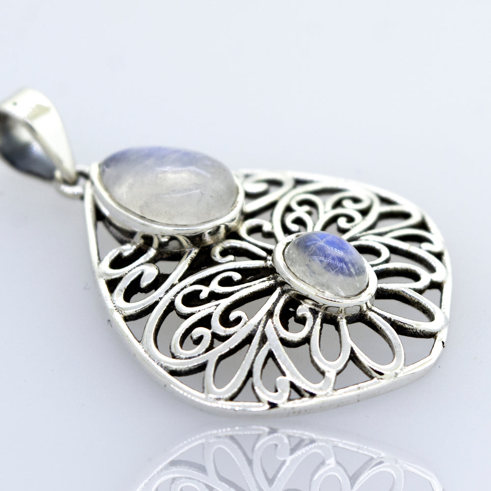 A Super Silver Moonstone Pendant with an intricate filigree design.