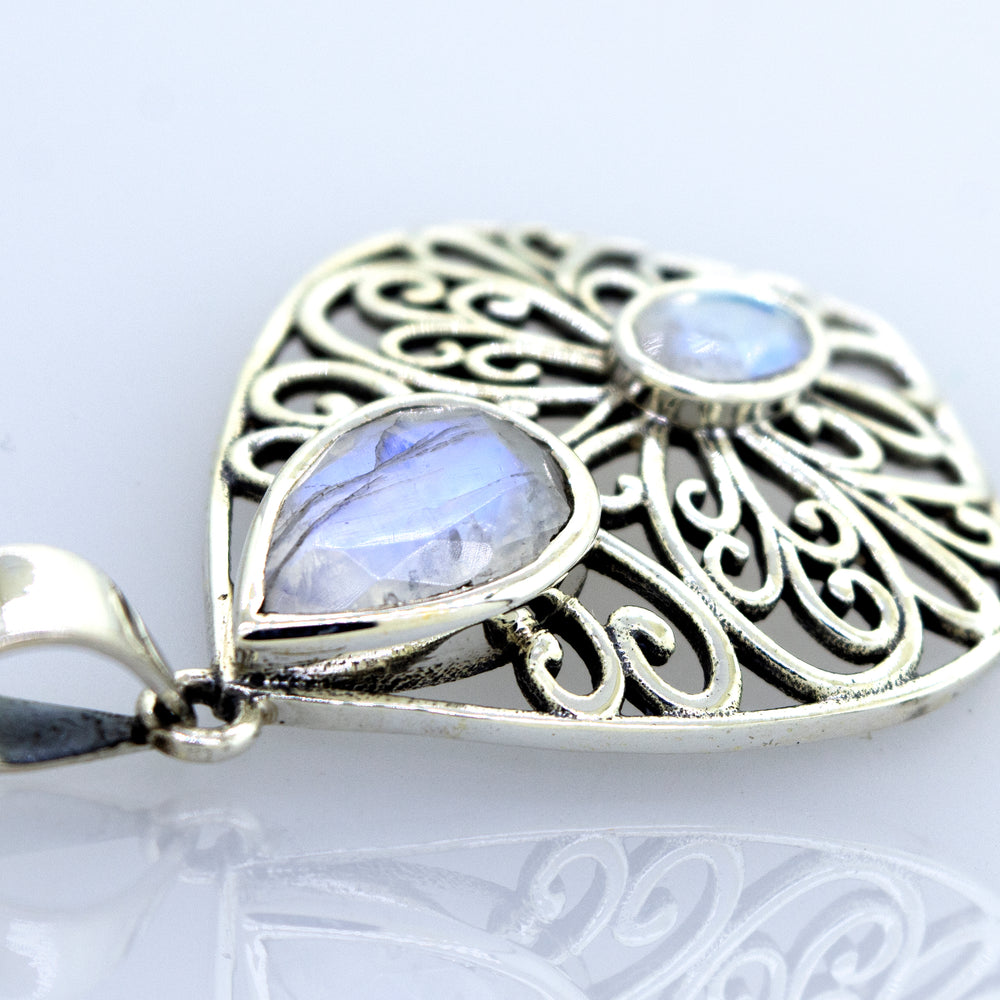 A Super Silver moonstone pendant featuring a delicate filigree design.