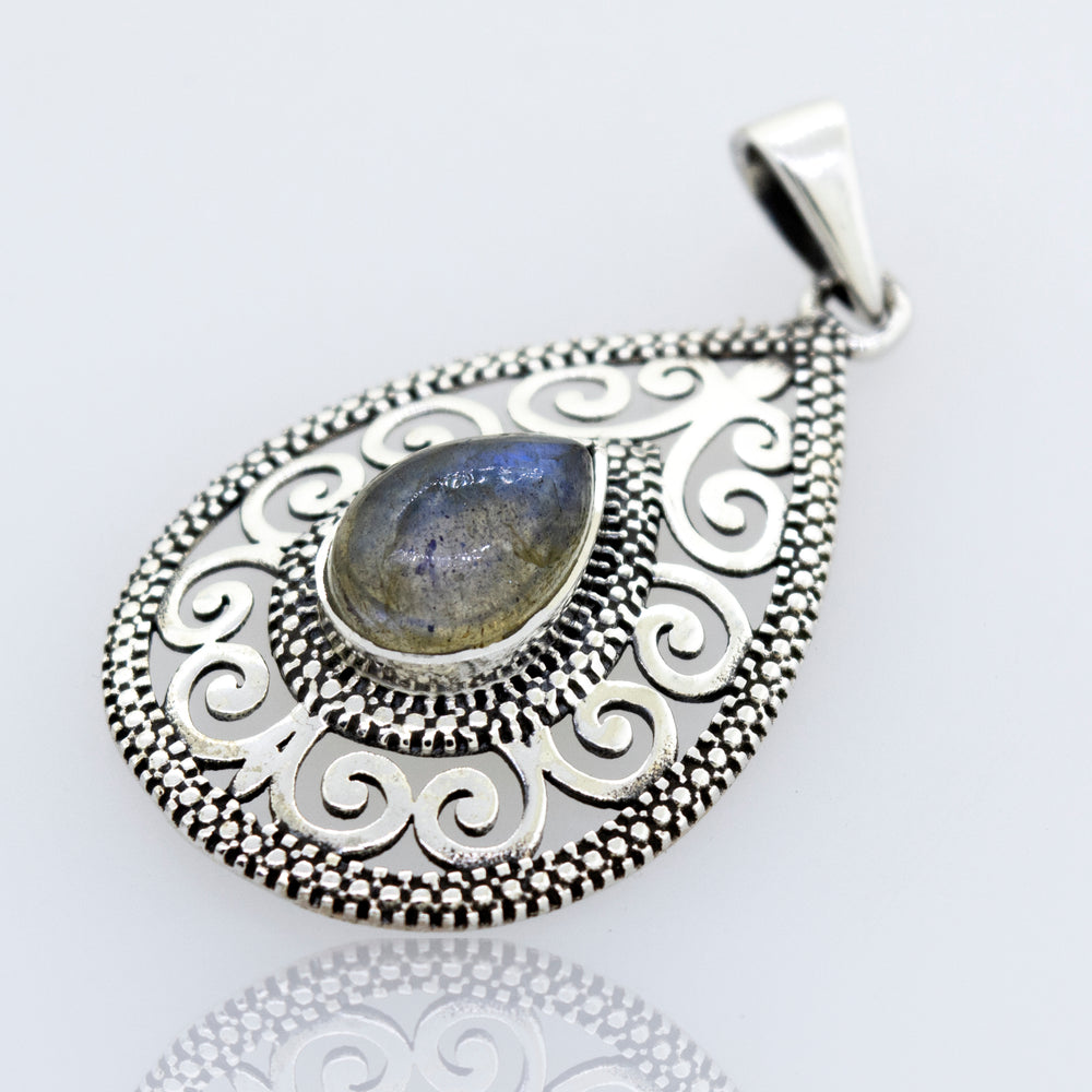 A filigree Super Silver Labradorite Teardrop Pendant featuring a beautiful Labradorite stone.