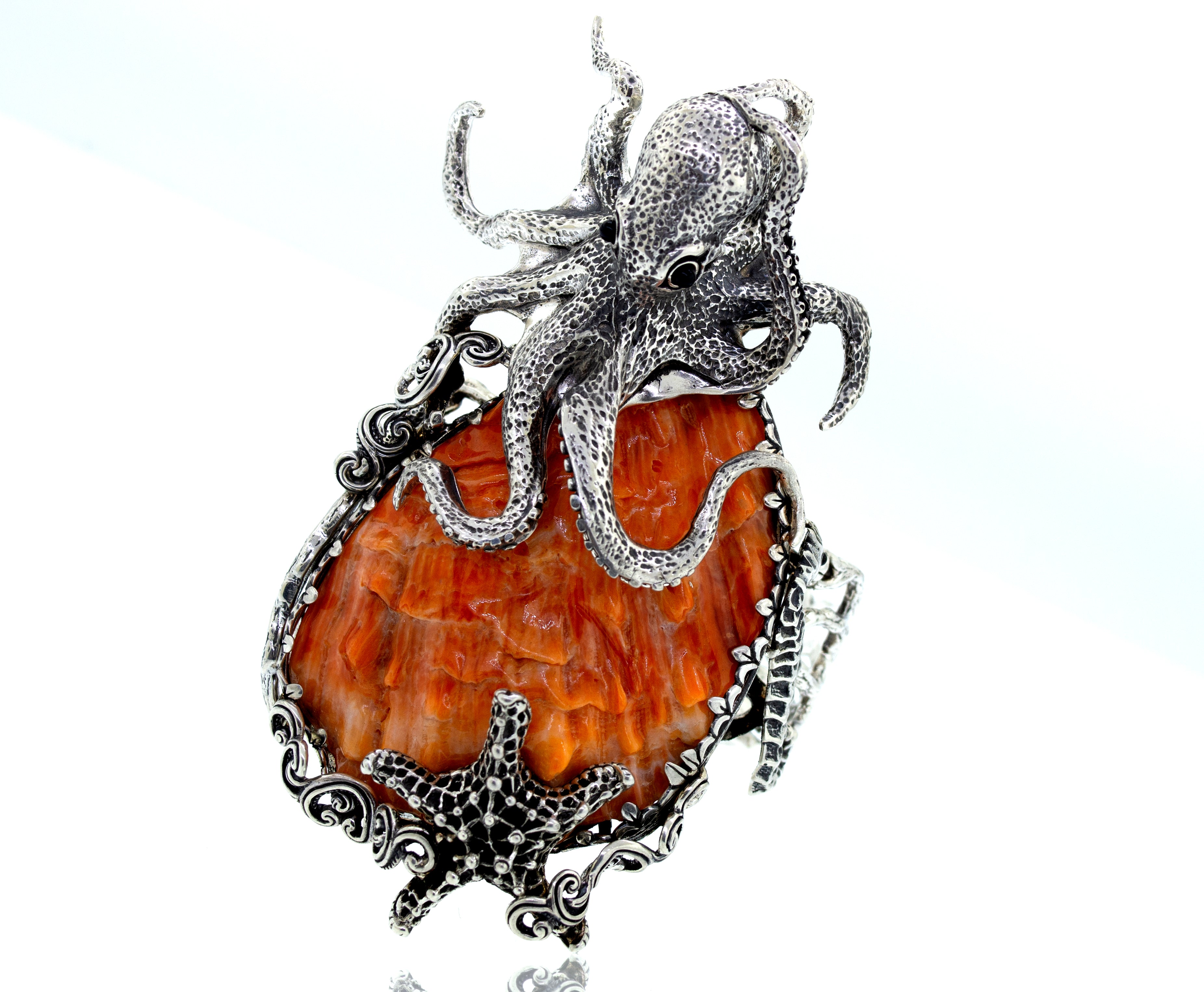 A Super Silver Handcrafted Spiny Shell Designer Cuff Bracelet featuring an intricate ocean life design with a starfish and octopus.