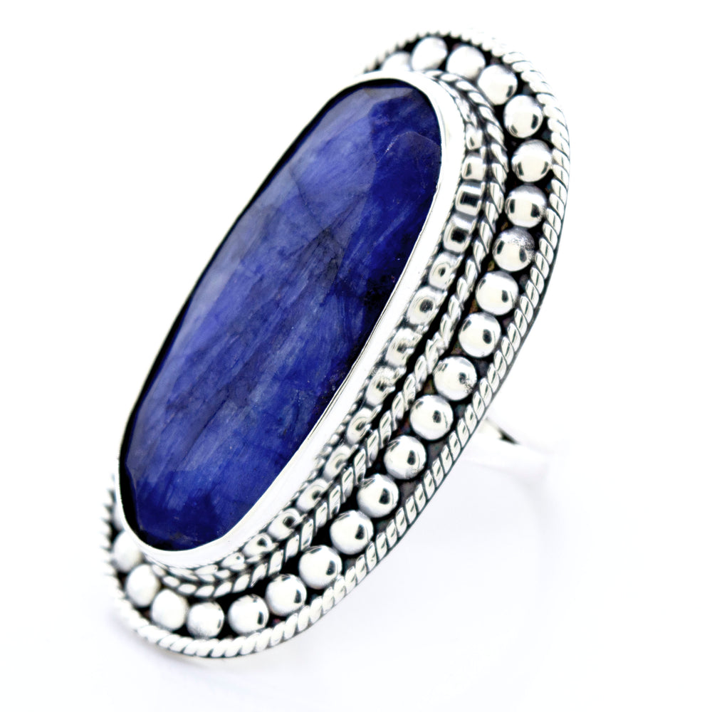 An Elegant Raw Blue Sapphire Ring by Super Silver, with a lapis stone.