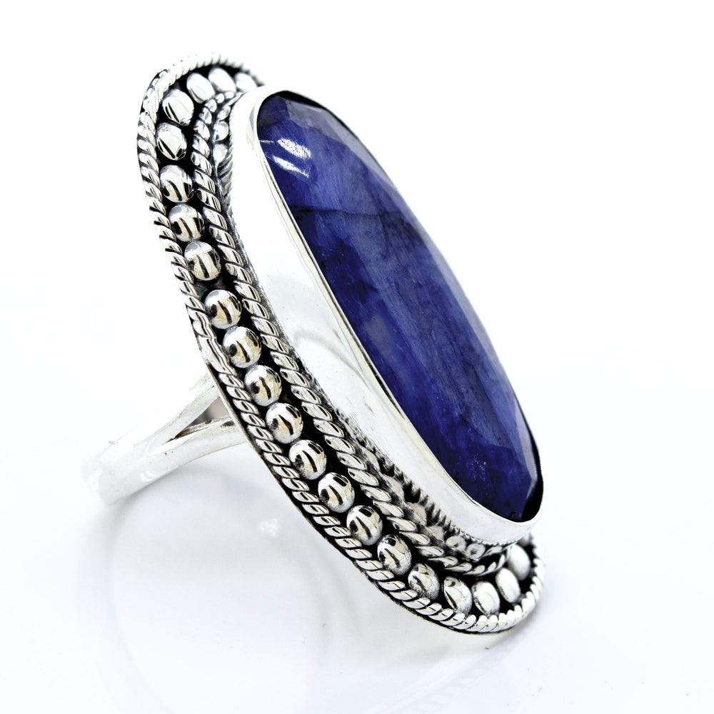An Elegant Raw Blue Sapphire Ring with a lapis stone in a silver setting, made by Super Silver.