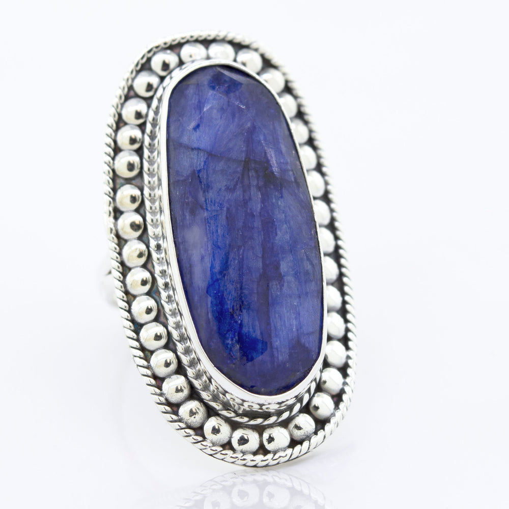 
                  
                    An Elegant Raw Blue Sapphire Ring by Super Silver with a lapis stone in a sturdy silver setting.
                  
                
