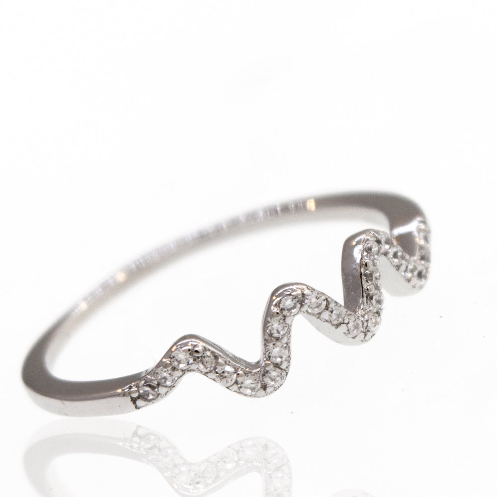 An elegant Wavy Pave Band engagement ring with diamonds on it.