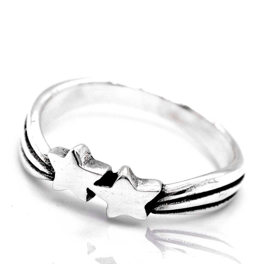 A sterling silver Double Shooting Star Ring featuring a simple band design with two interlocked shooting star shapes at the top, set against a white background.