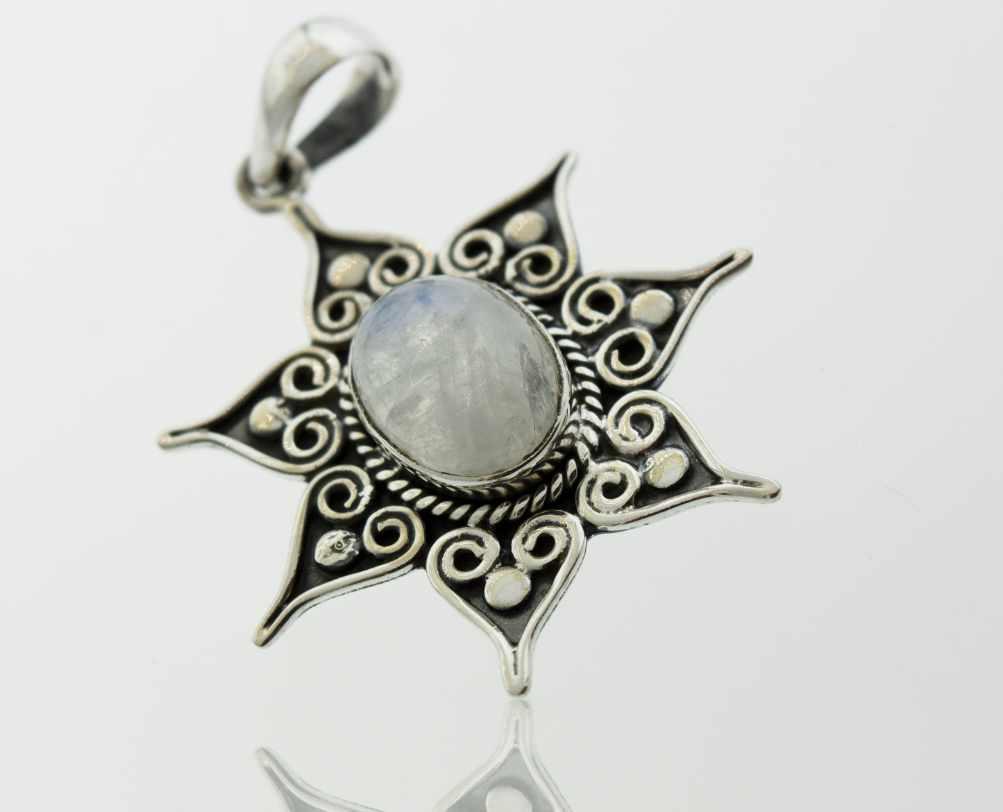 A Super Silver moonstone pendant with a flower star setting, adorned with delicate spirals.