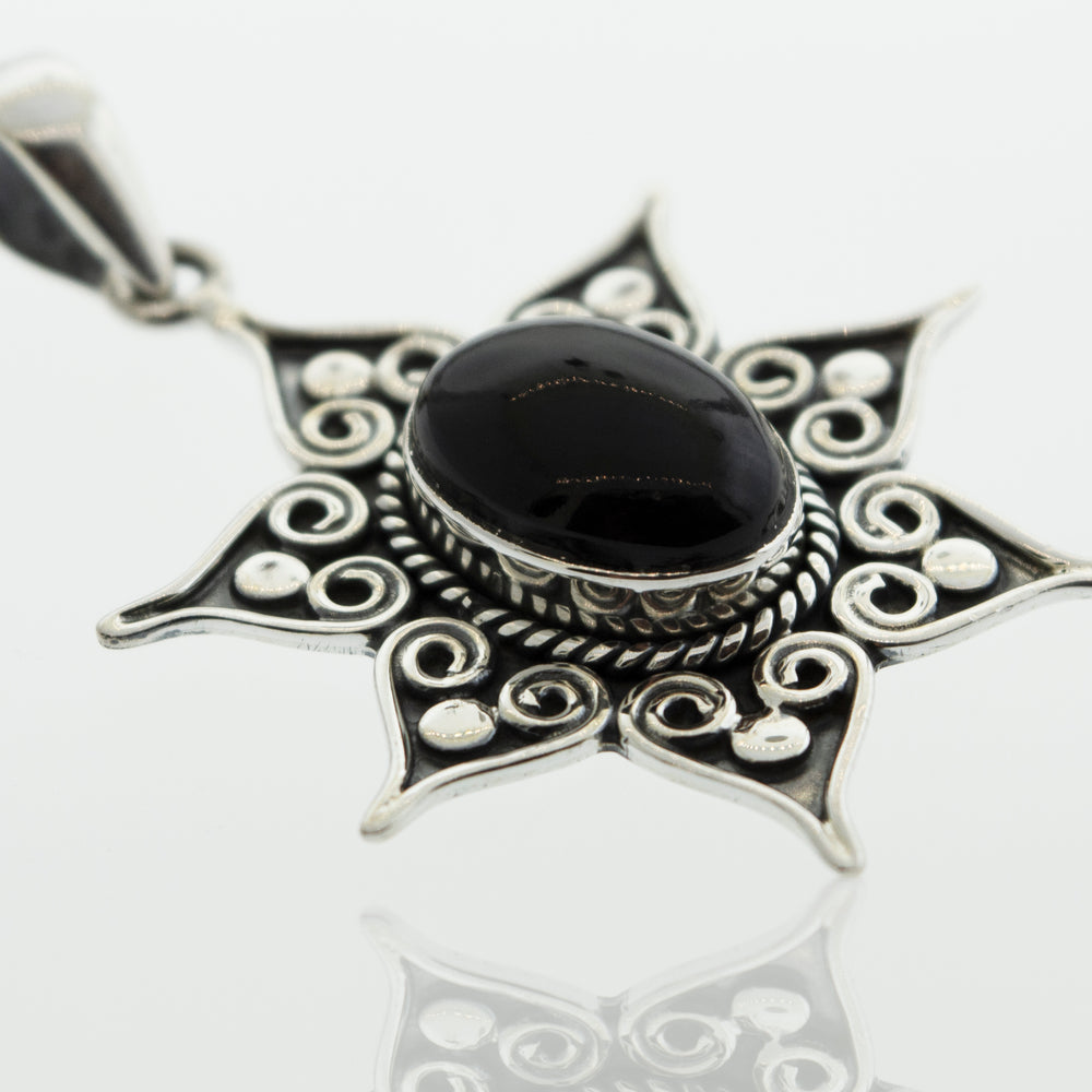 A gorgeous Super Silver Ruby Pendant with a black onyx stone in a flower setting.