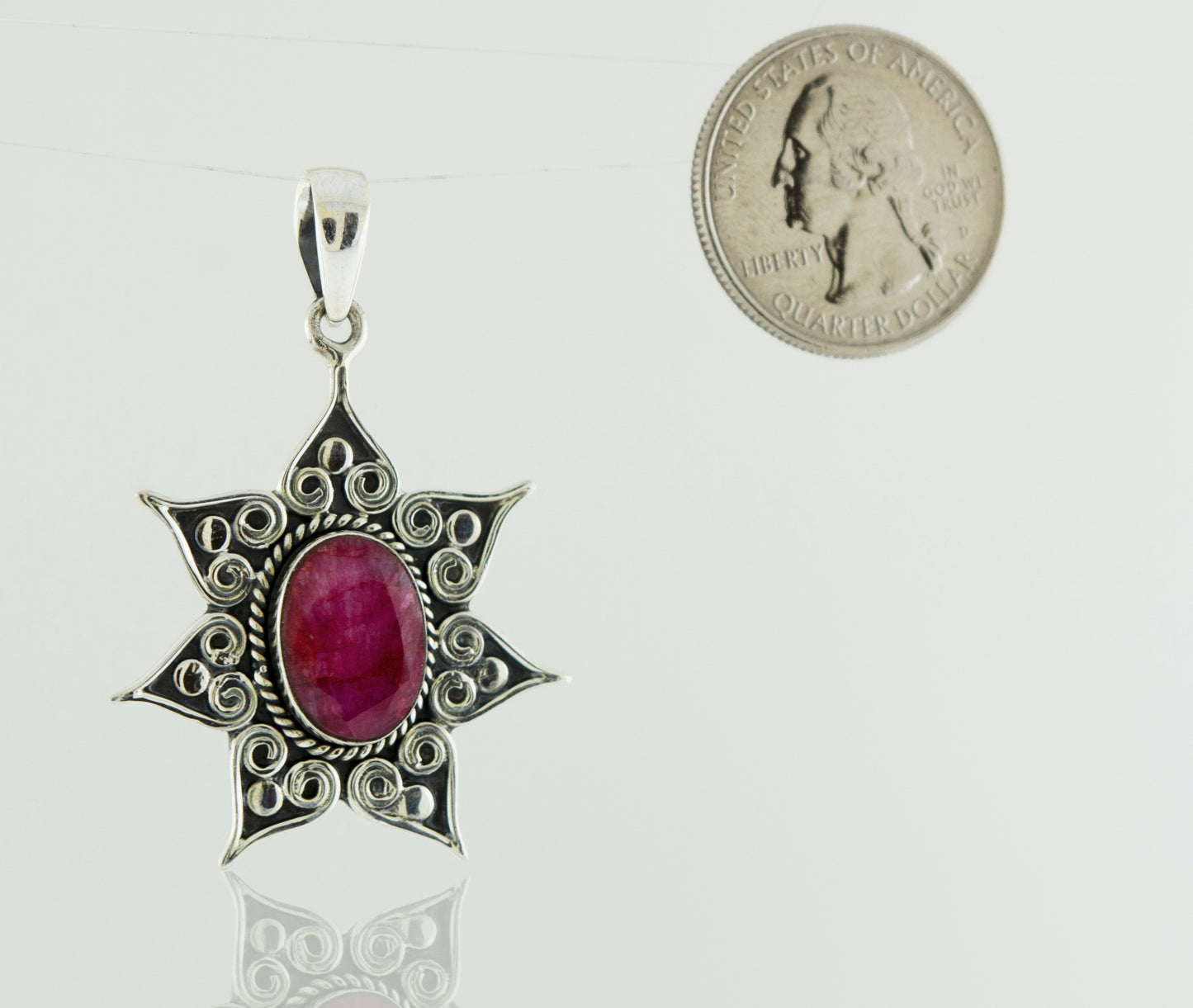 A Super Silver Onyx Pendant, featuring a flower star setting.