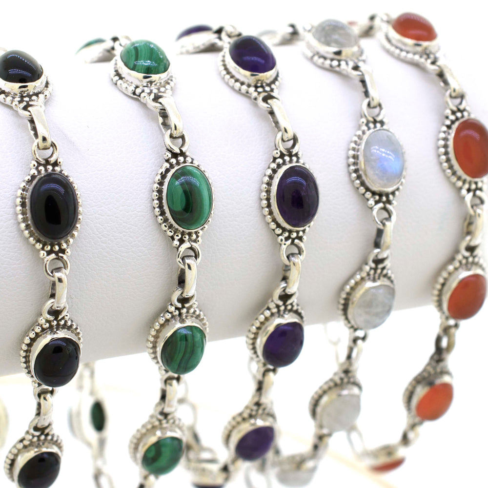 
                  
                    A set of Oval Gemstone Bracelets with different colored stones, all delicately crafted in sterling silver, branded as Super Silver.
                  
                