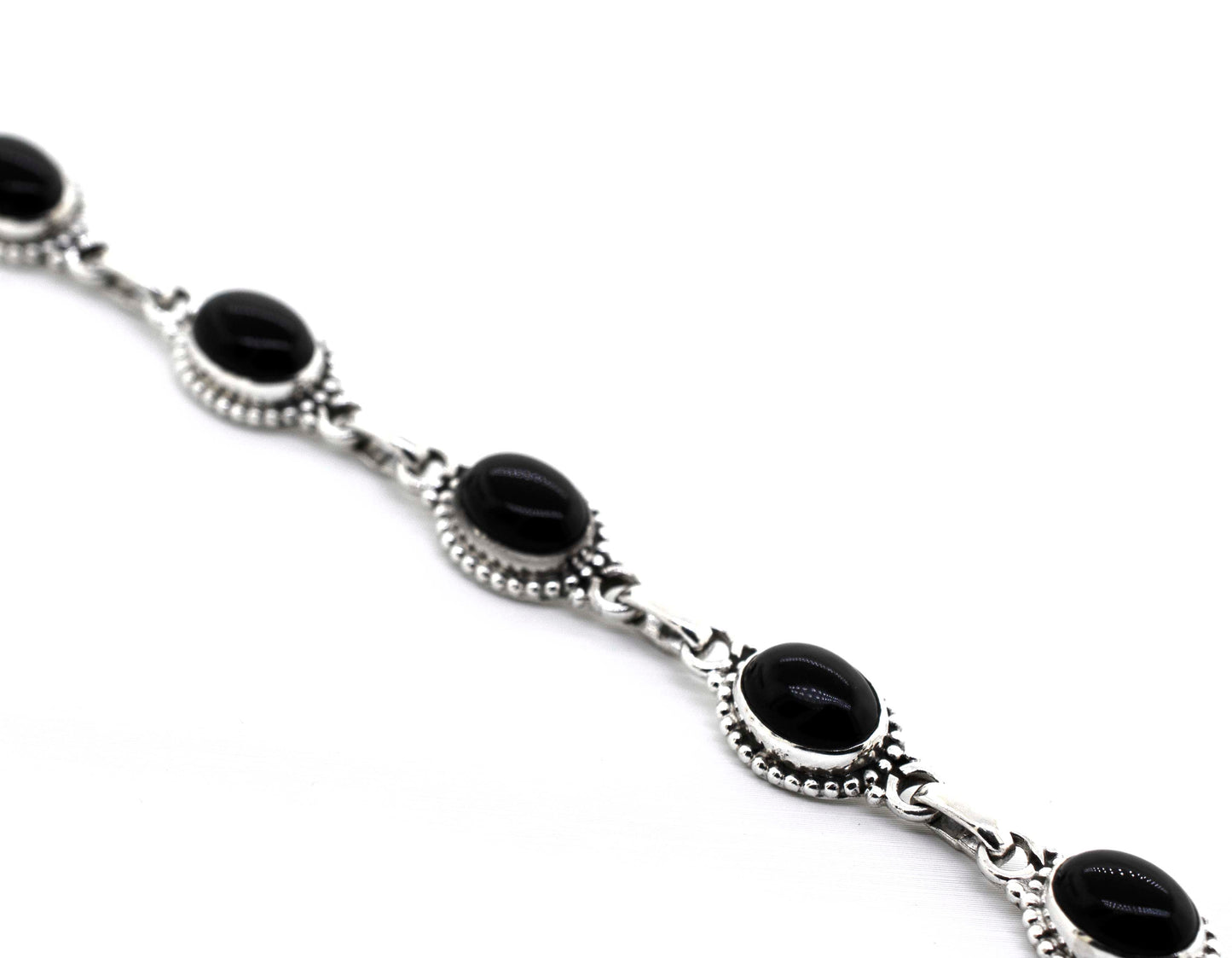 
                  
                    A Super Silver Oval Gemstone Bracelet With Ball Border featuring black onyx stones.
                  
                