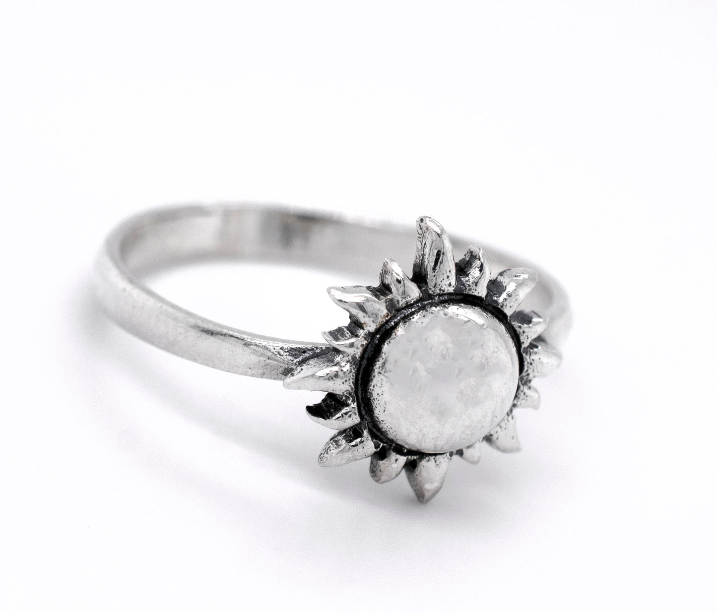 A minimalist style Super Silver  Silver Sun Ring with a white stone in the center.