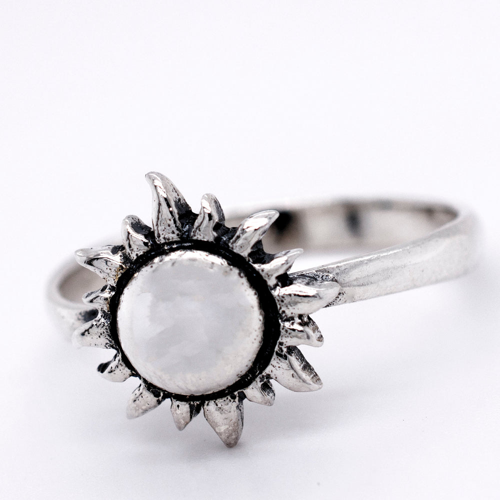 A Silver Sun Ring by Super Silver, with a white stone in the middle, boasting a minimalist style.