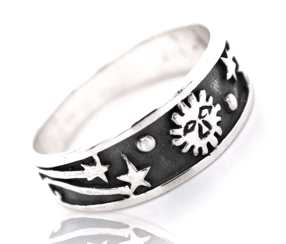 A boho-inspired Galaxy Ring With Shooting Stars adorned with celestial motifs of stars and suns.
