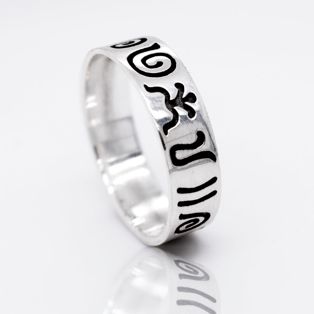 A Super Silver Aztec Symbols Band with a black and white design featuring carved Aztec symbols, giving it an oxidized look.