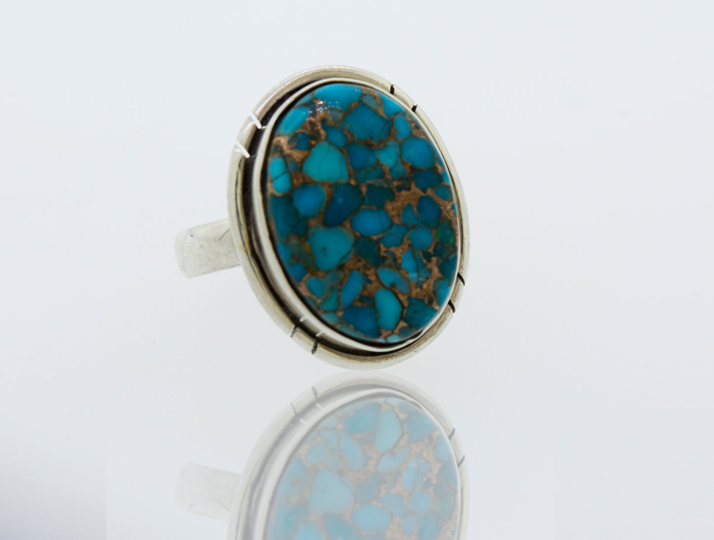
                  
                    A Natural Blue Copper Turquoise Ring with an oval turquoise stone in the center, crafted in sterling silver by Super Silver.
                  
                