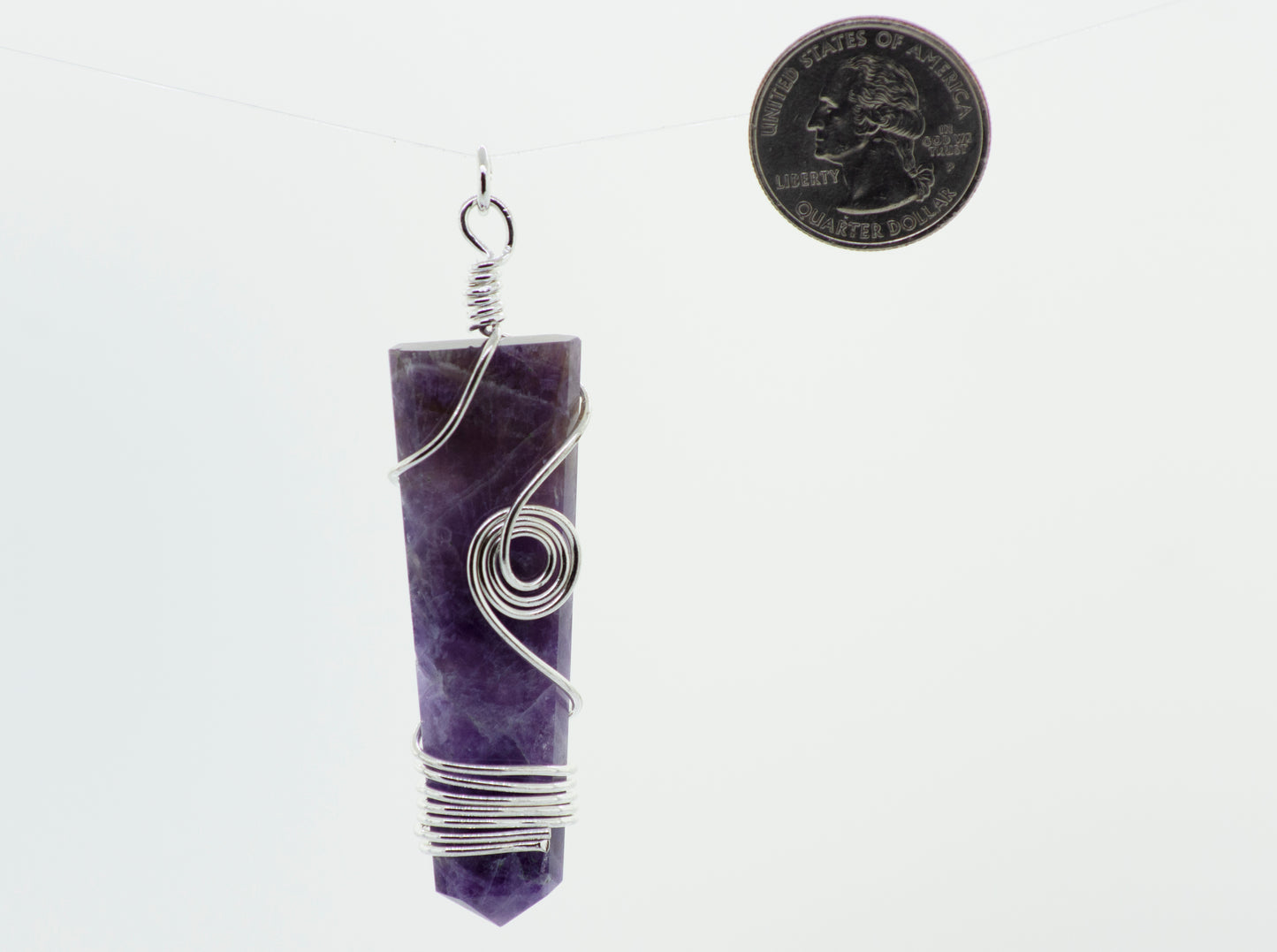 
                  
                    A Stone Slab pendant with wire wrapping hanging from a Super Silver chain.
                  
                