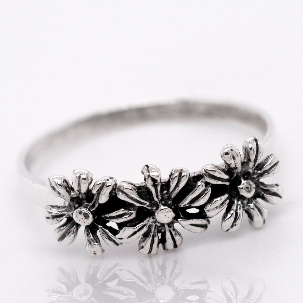 
                  
                    Floral-inspired dainty three flowers design ring in sterling silver.
                  
                