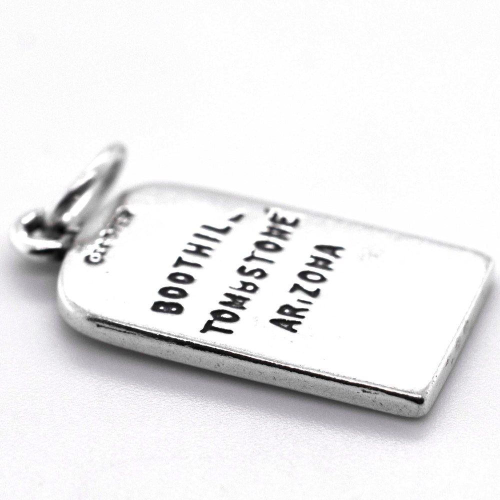 
                  
                    A silver charm with the words "Lester Moore Gravestone Charm" and "Super Silver" on it.
                  
                