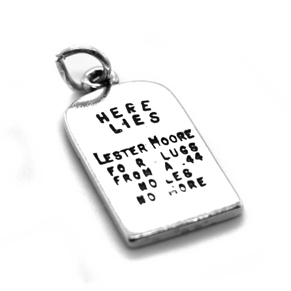 
                  
                    A Super Silver Lester Moore Gravestone Charm with the words 'here lies' on it, inspired by the Wild West era.
                  
                