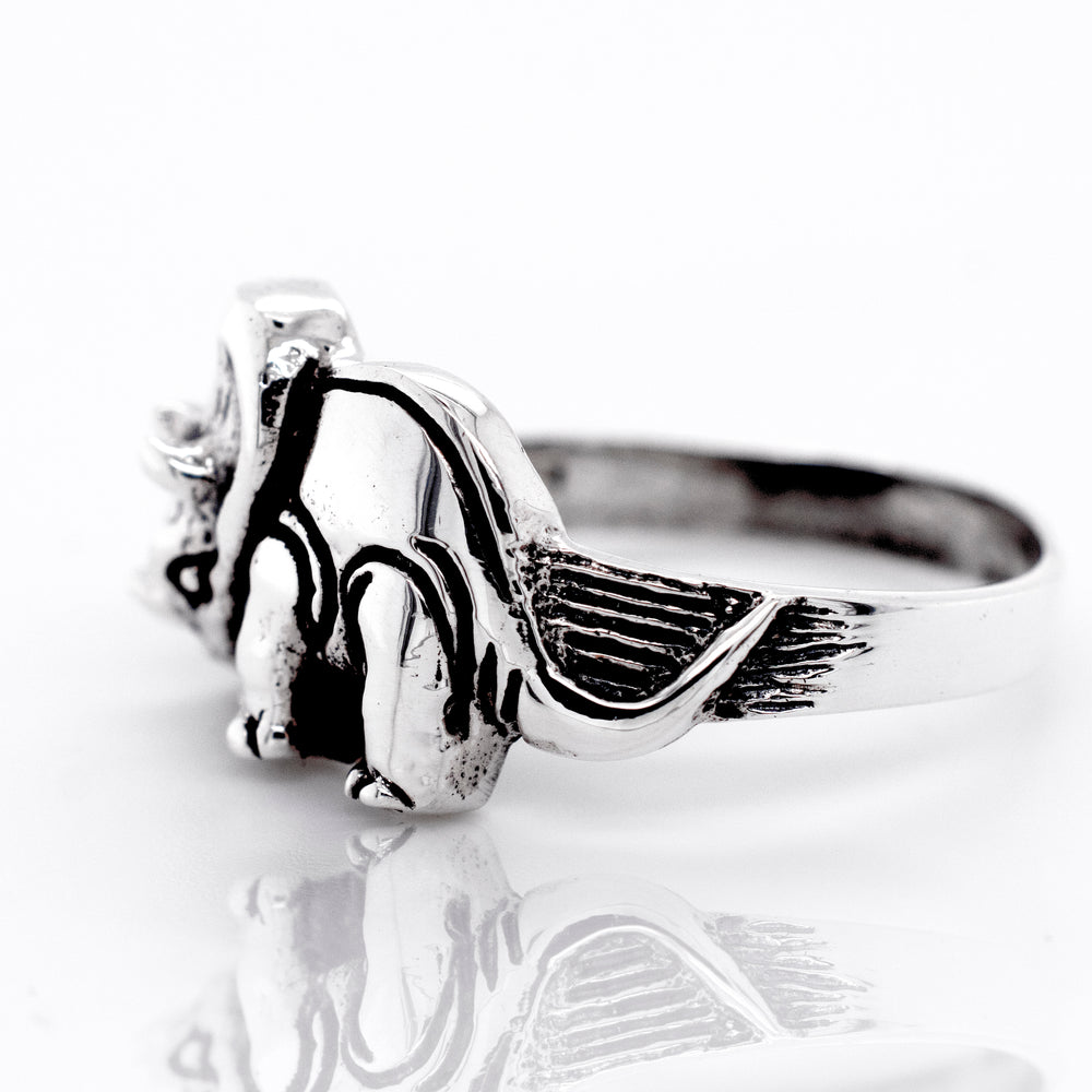 A Triceratops Ring by Super Silver with a teddy bear design on a wide silver band.