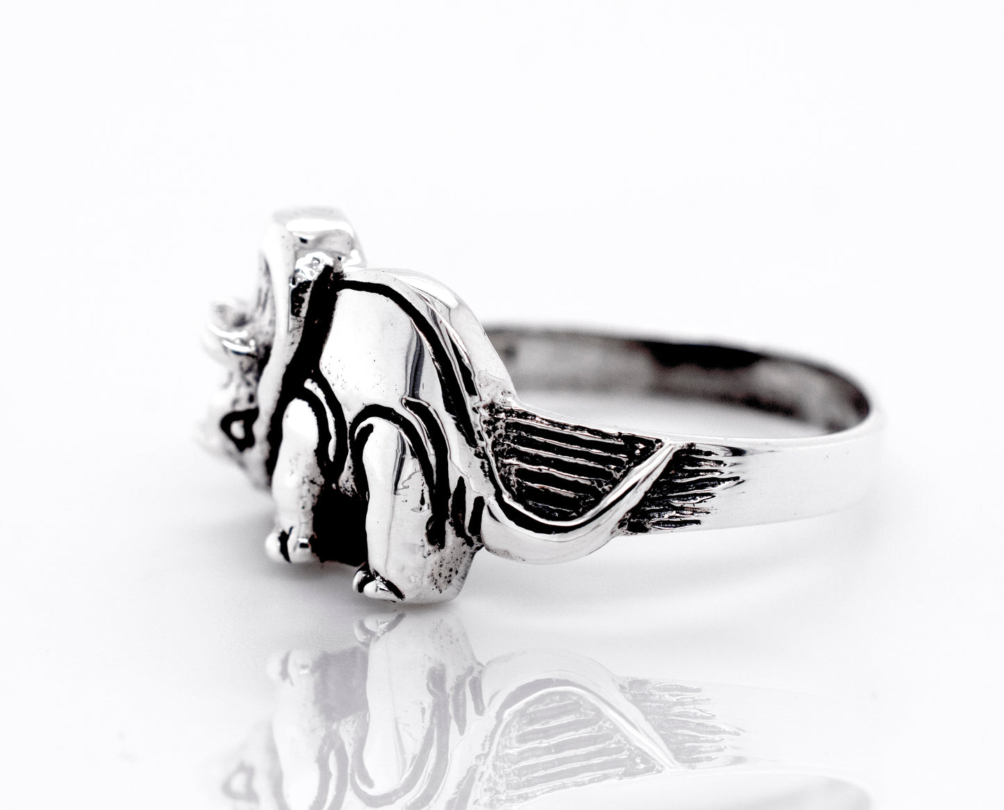 A Triceratops Ring by Super Silver with a teddy bear design on a wide silver band.