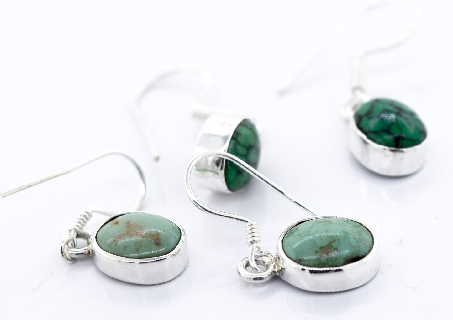 A pair of Super Silver oval natural turquoise dangle earrings with oval-shaped green stones.