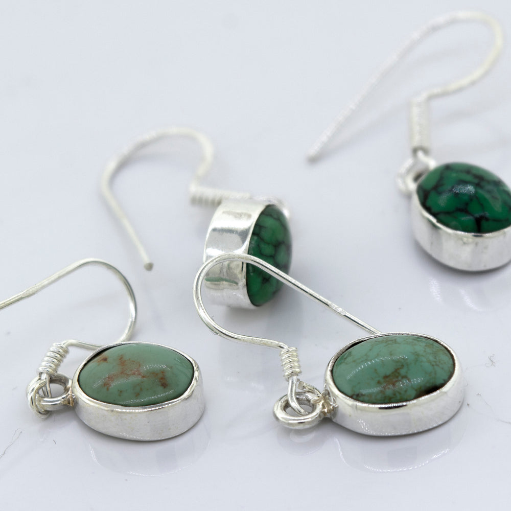 
                  
                    A pair of Super Silver oval natural turquoise dangle earrings, featuring oval-shaped natural turquoise stones, adds a touch of elegance to any outfit.
                  
                