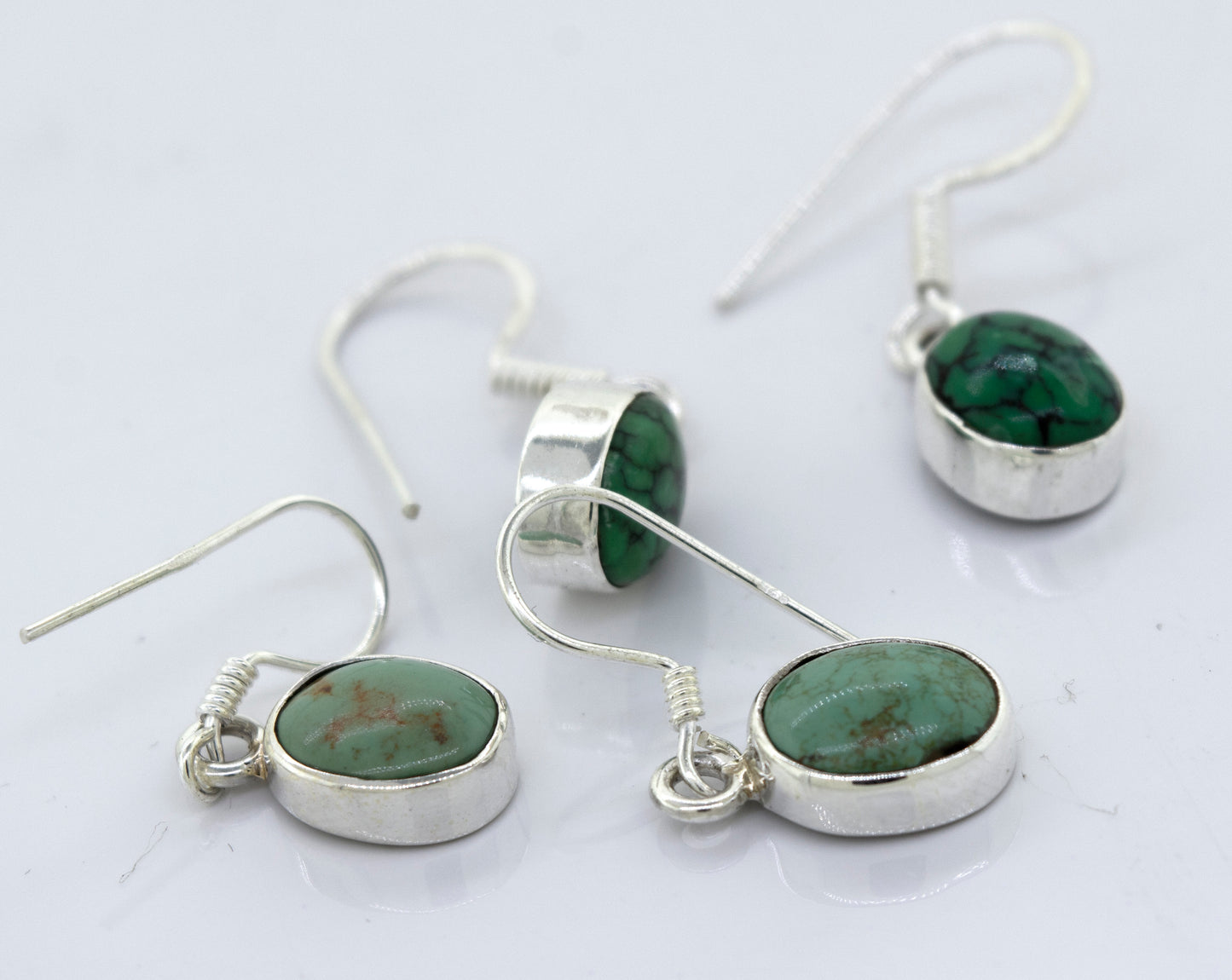 
                  
                    A pair of Super Silver oval natural turquoise dangle earrings, featuring oval-shaped natural turquoise stones, adds a touch of elegance to any outfit.
                  
                