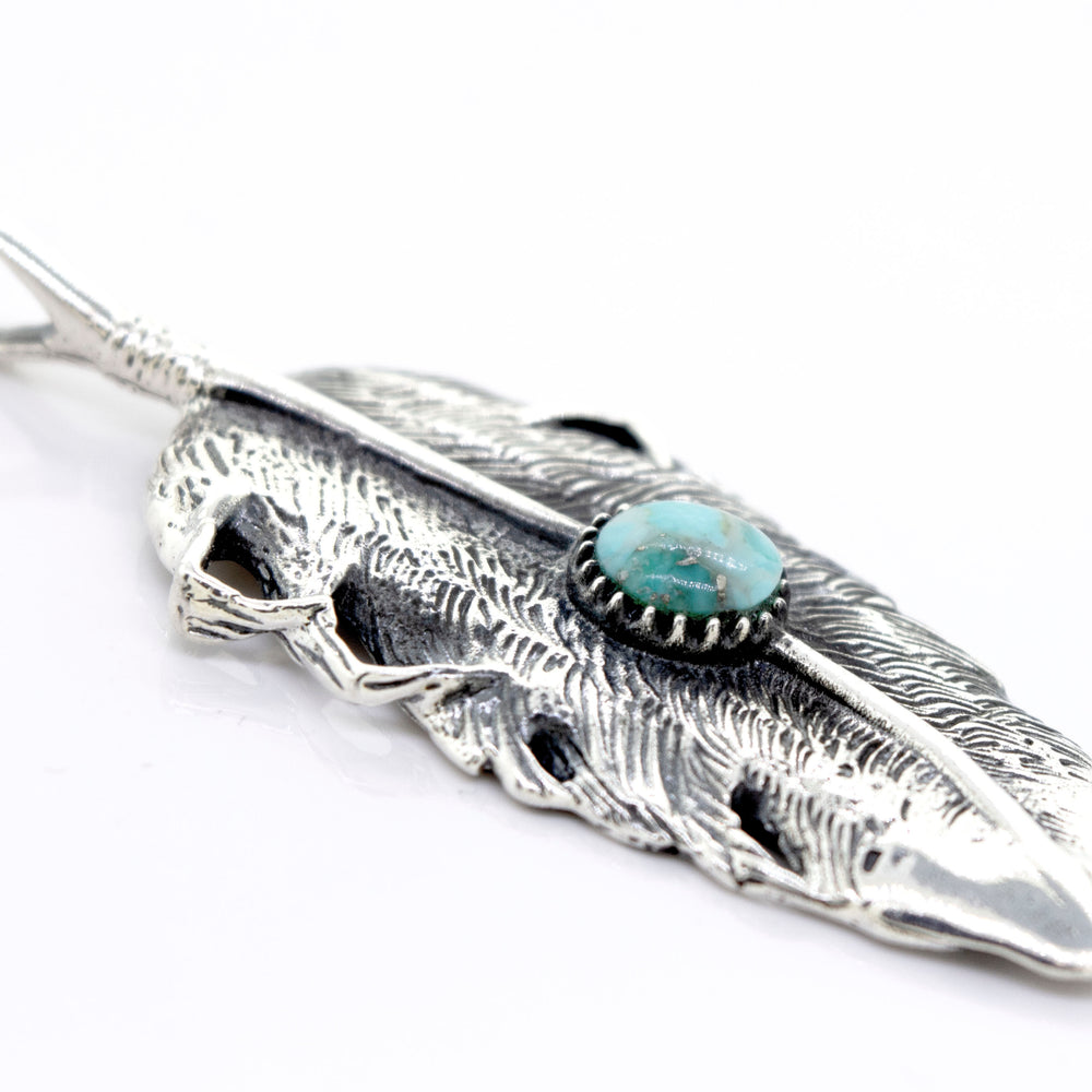 
                  
                    The Super Silver Native Inspired Feather Pendant With Turquoise adorns this sterling silver feather design pendant.
                  
                