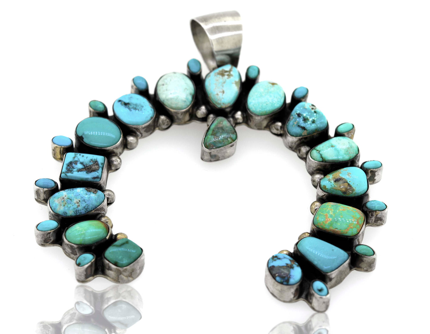 A Super Silver Stunning Handcrafted Naja Pendant with turquoise stones.