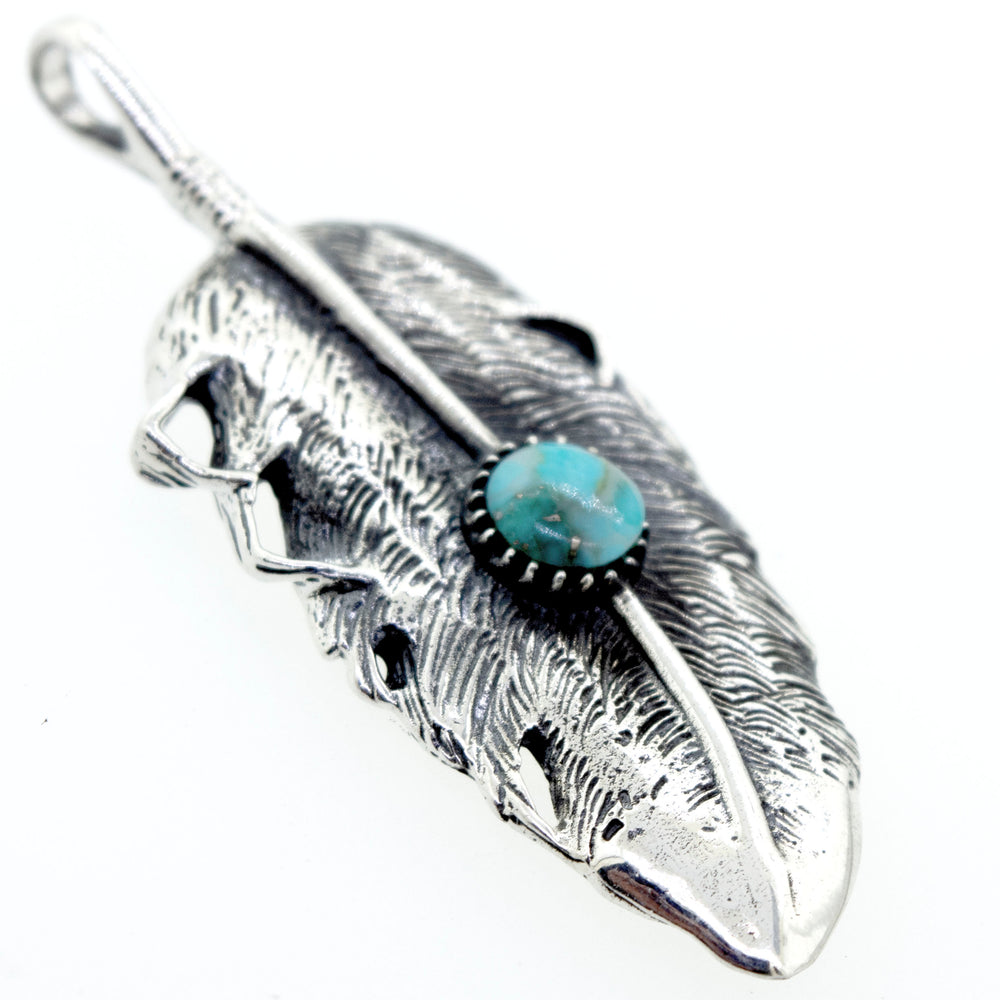 
                  
                    Round Native Inspired Feather Pendant With Turquoise set in .925 Super Silver design.
                  
                