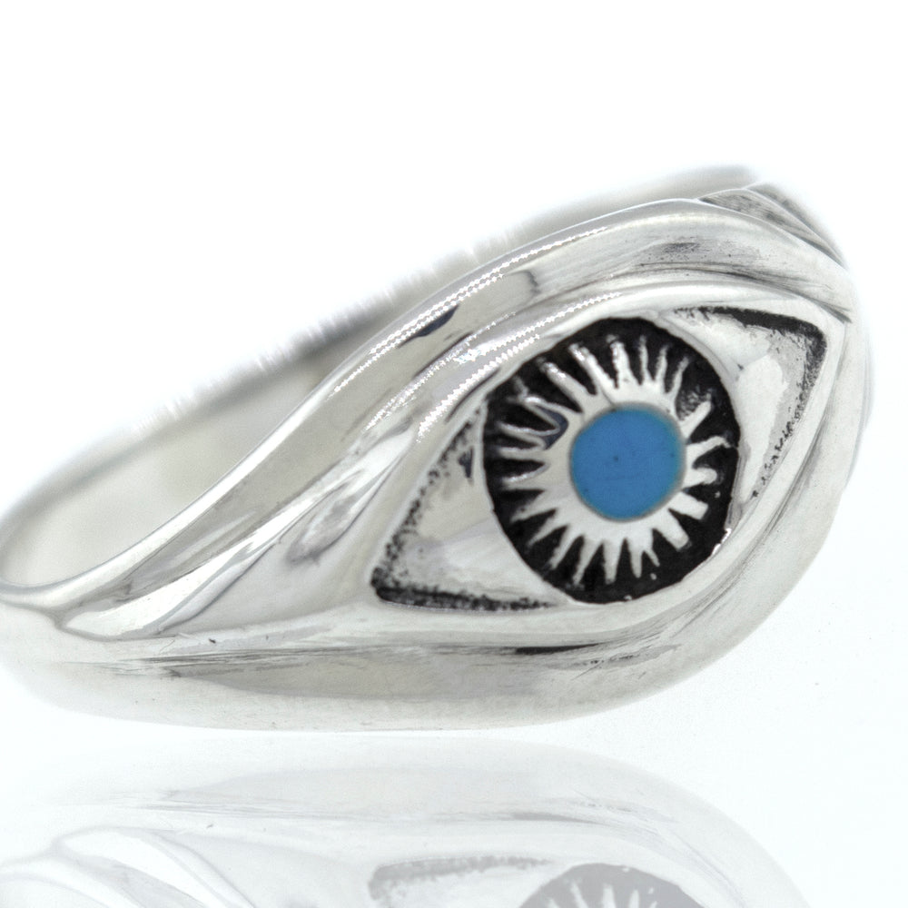 A Super Silver turquoise eye ring with an evil eye on it.