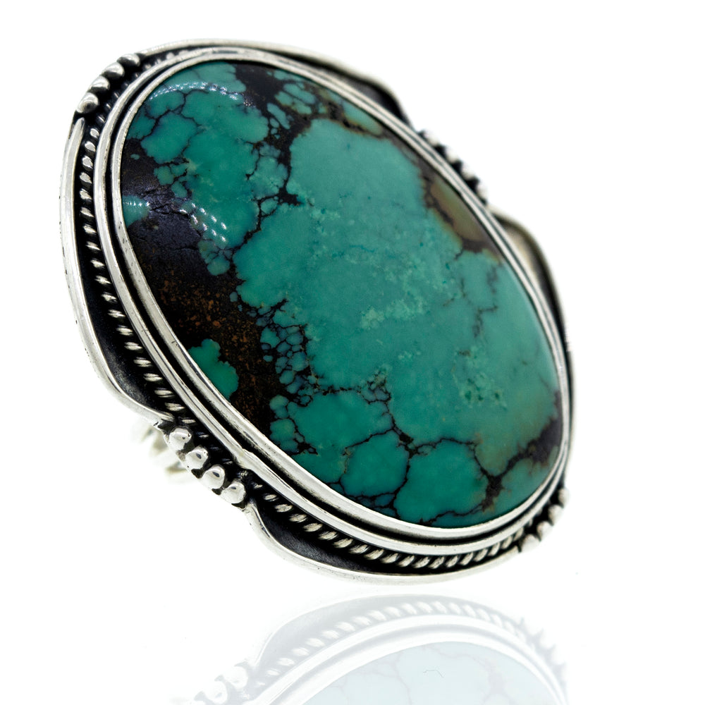
                  
                    A Super Silver Oval Natural Turquoise Ring With Rope And Ball Border adorned with a gorgeous turquoise stone.
                  
                