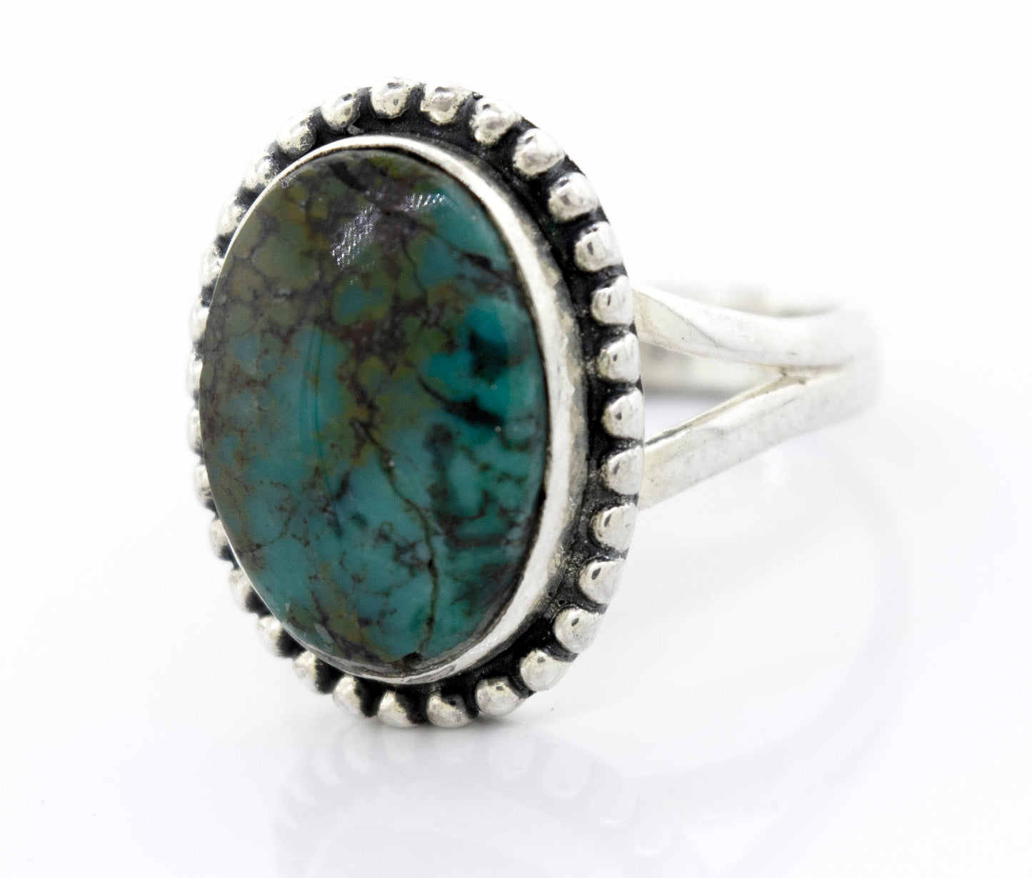 A Super Silver oval natural turquoise ring with a ball border.