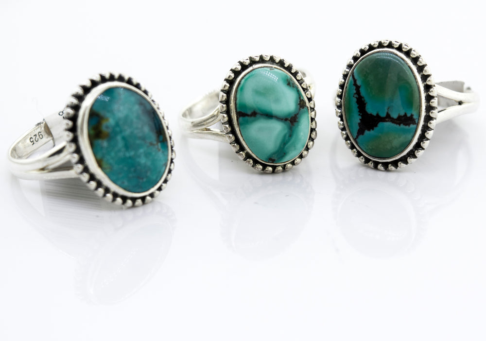 Three Super Silver Oval Natural Turquoise rings featuring a ball design on a white surface.