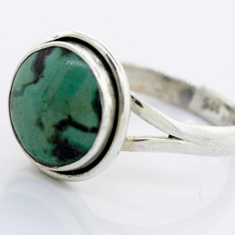 
                  
                    A Round Natural Turquoise Ring With Plain Border by Super Silver.
                  
                