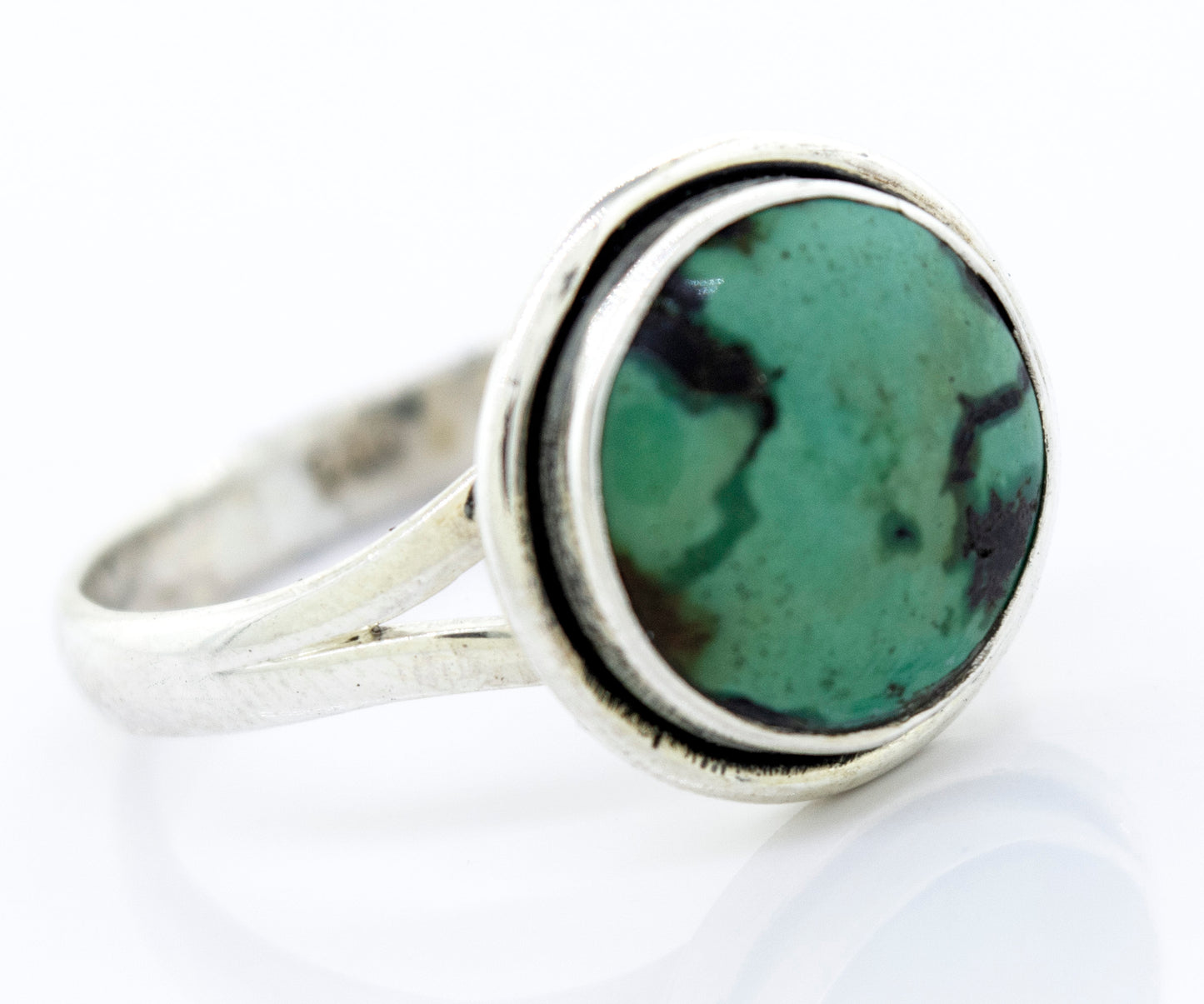 A Round Natural Turquoise Ring With Plain Border set in sterling silver.