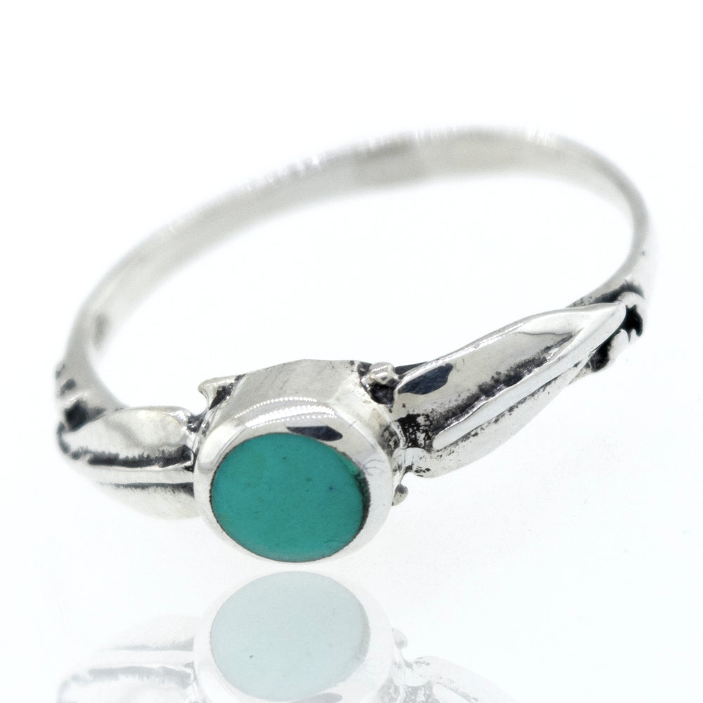 
                  
                    A sterling silver Round Stone Ring With Leaves with delicate leaf details.
                  
                