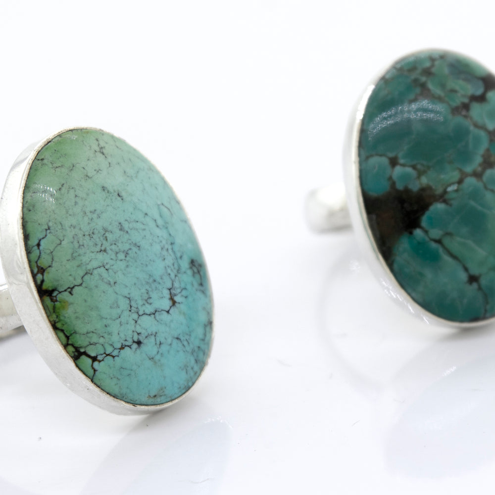 
                  
                    A pair of unique Oval Natural Turquoise Rings with a sterling silver setting, showcasing the natural beauty and vibrance of the turquoise stones. These rings are from Super Silver.
                  
                