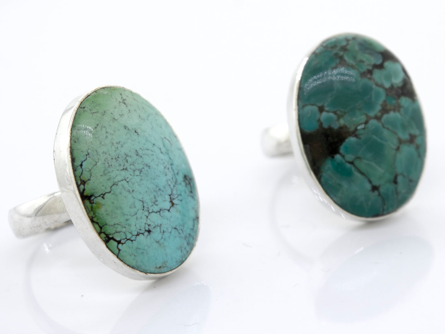 
                  
                    A pair of unique Oval Natural Turquoise Rings with a sterling silver setting, showcasing the natural beauty and vibrance of the turquoise stones. These rings are from Super Silver.
                  
                