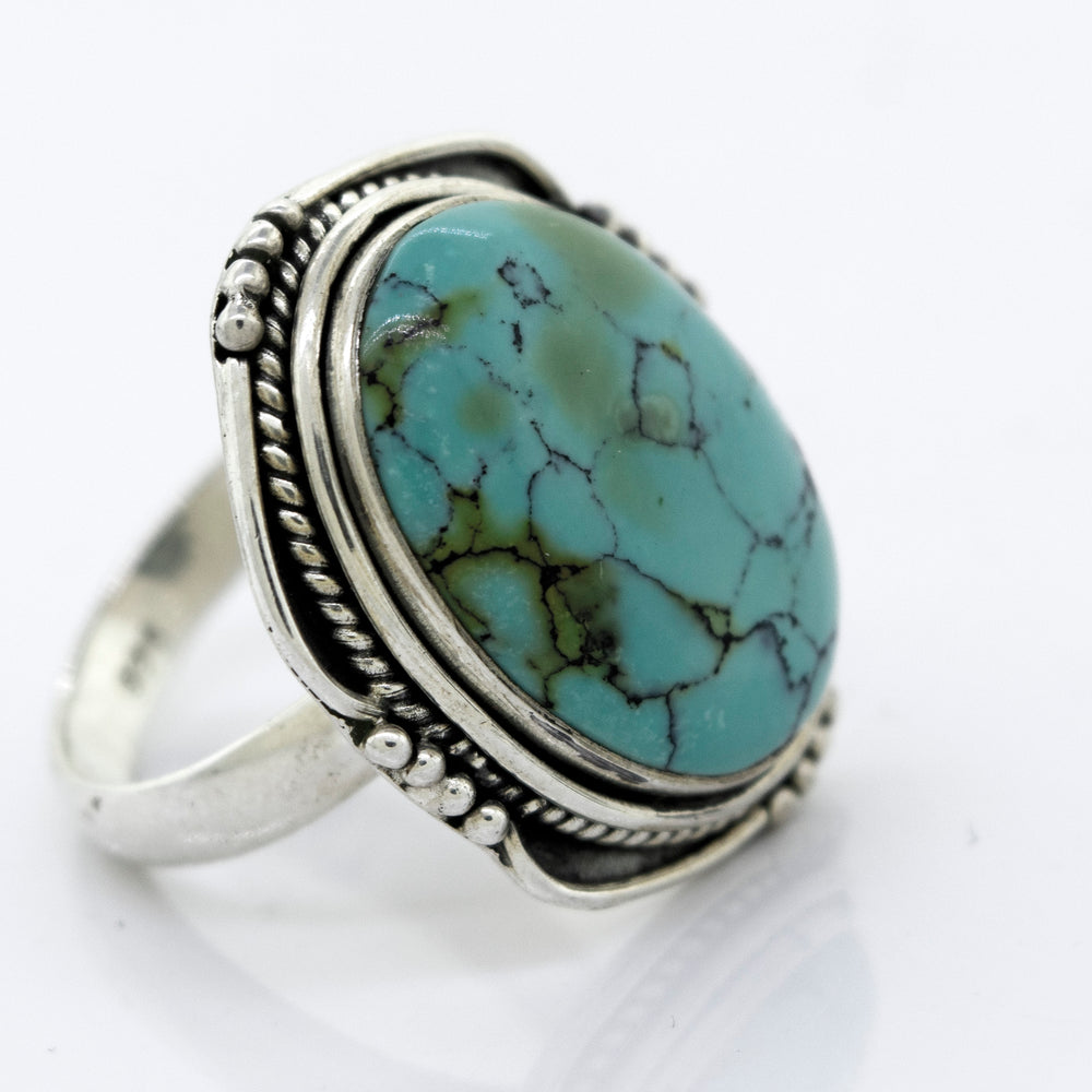A Super Silver natural turquoise ring with a rope design.