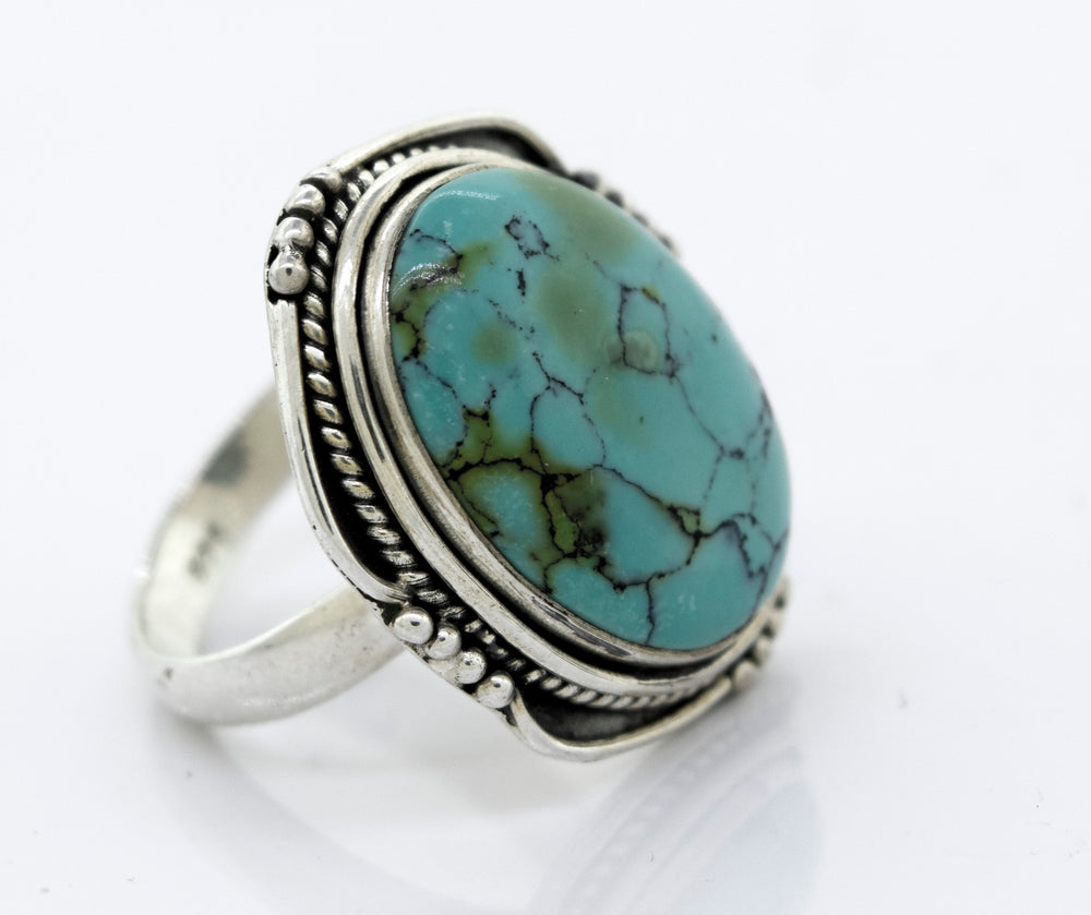 
                  
                    A Super Silver natural turquoise ring with a rope design.
                  
                