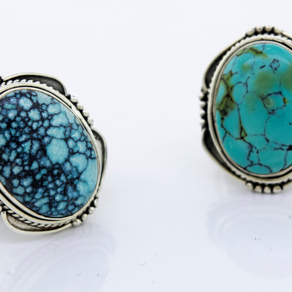 A pair of oval-shaped Super Silver sterling silver rings with natural turquoise stones.