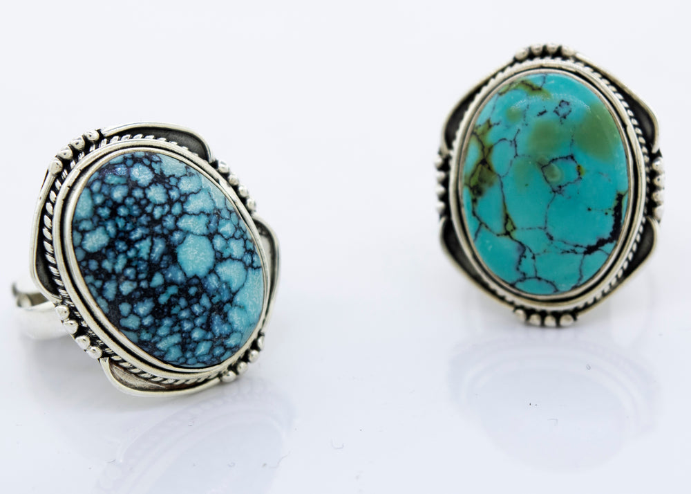
                  
                    A pair of oval-shaped Super Silver sterling silver rings with natural turquoise stones.
                  
                